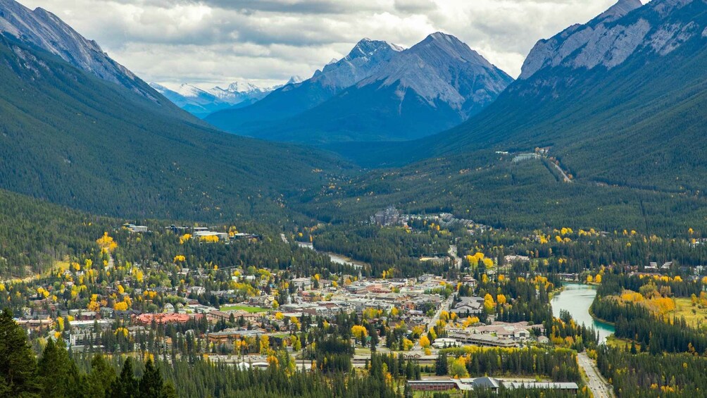 A valley with a town, mountains, and a river. 2