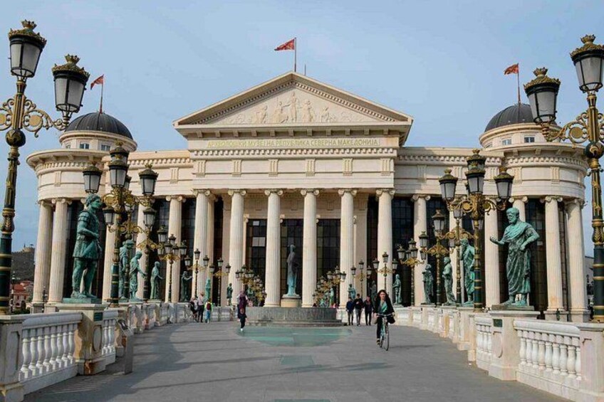 A neoclassical building with columns, statues, and a central dome. 3