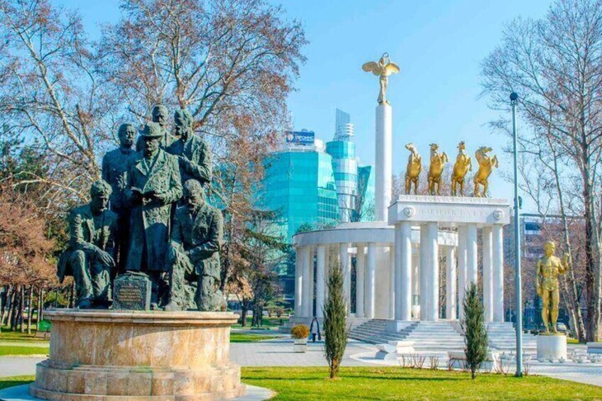 A statue of historical figures, a white monument with columns, and a golden statue of a horseman. 2