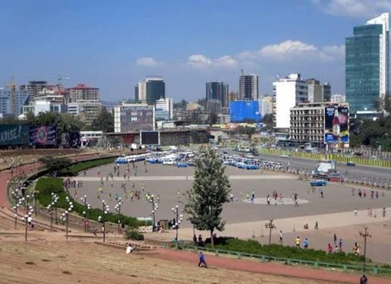 A cityscape with a central open plaza, surrounded by buildings and a clear sky. 3