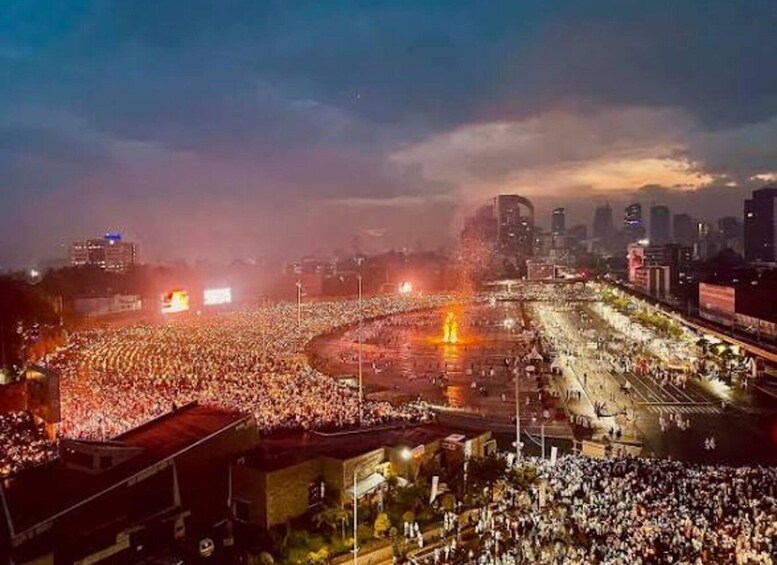 A large crowd gathered in an urban setting at night. 2