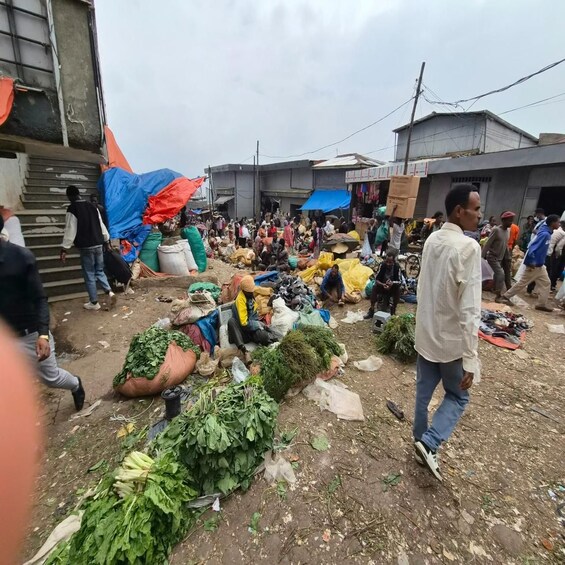 A bustling outdoor market with people and goods. 3
