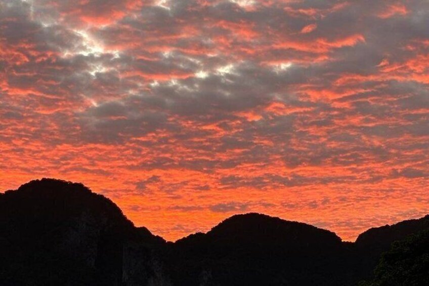 A sunset over a mountainous landscape with a vibrant sky. 3