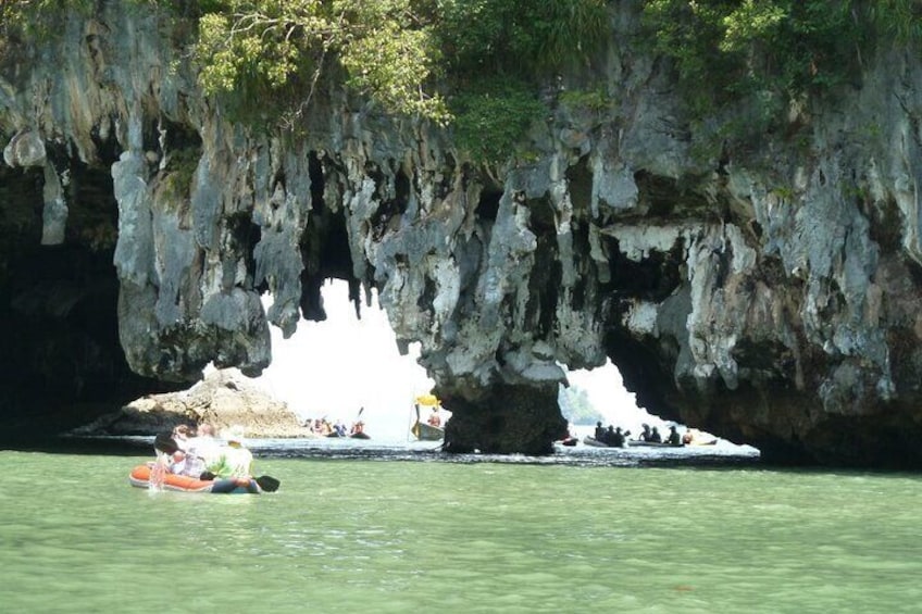 A cave entrance with water and boats. 1