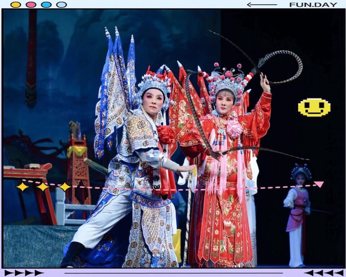 Two performers in traditional Chinese opera costumes with elaborate headpieces and accessories. 3