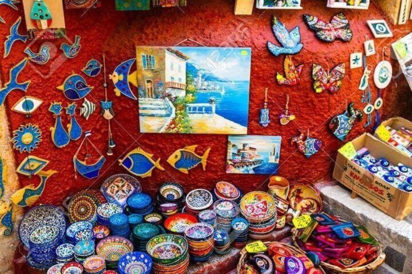 A vibrant display of colorful pottery, decorative items, and paintings. 5