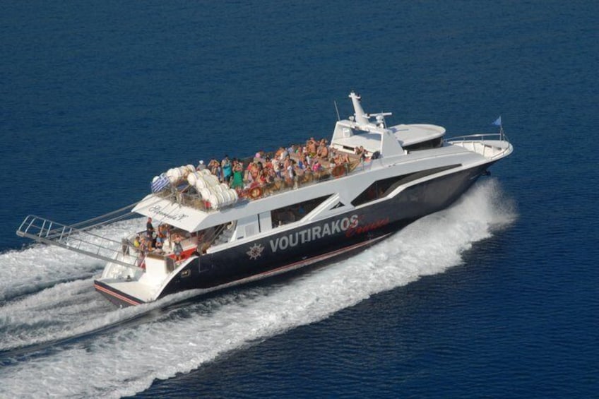 A large boat named 'VOUTIRAKOS' with passengers on deck, moving through the water. 4