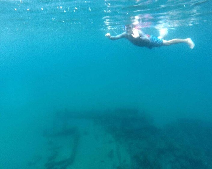 A person swimming underwater. 4