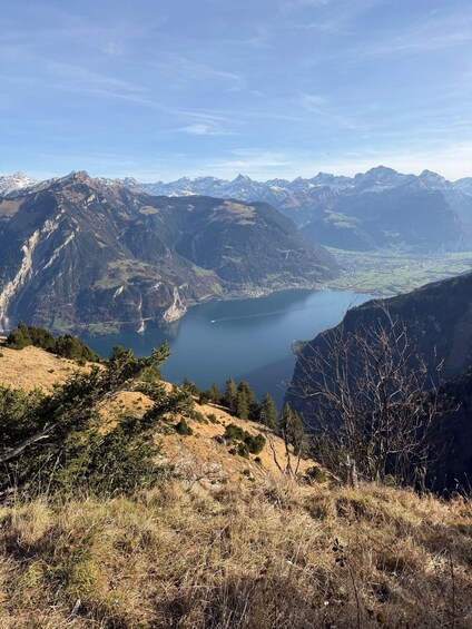 A mountainous landscape with a lake and a town in the valley below. 5
