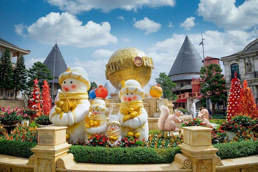 A garden with snowmen, a golden globe, and a fountain. 3