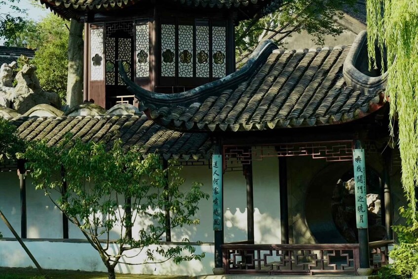 A traditional Chinese building with ornate tiled roofs and a decorative gate. 5