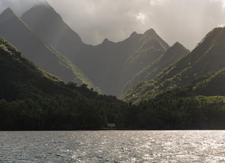 A mountainous landscape with a body of water in the foreground. 5