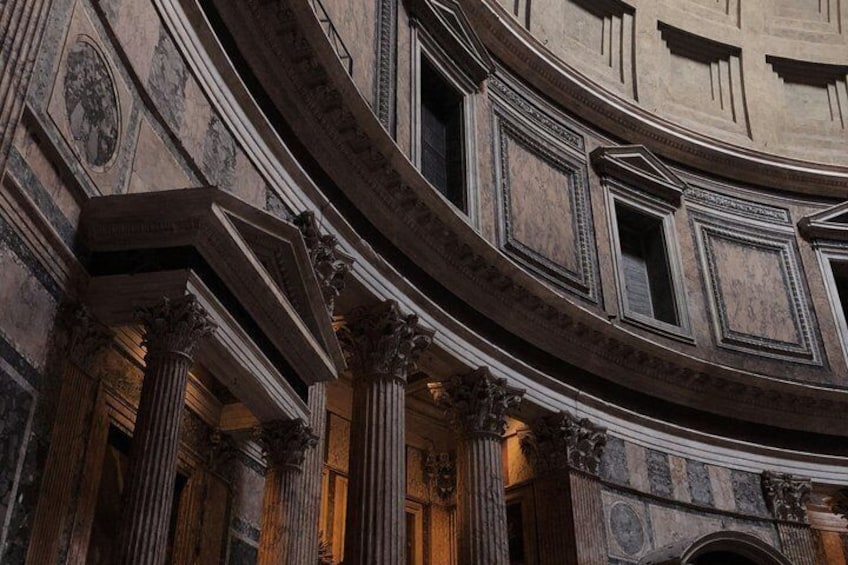 A grand architectural interior with classical columns and detailed carvings. 4