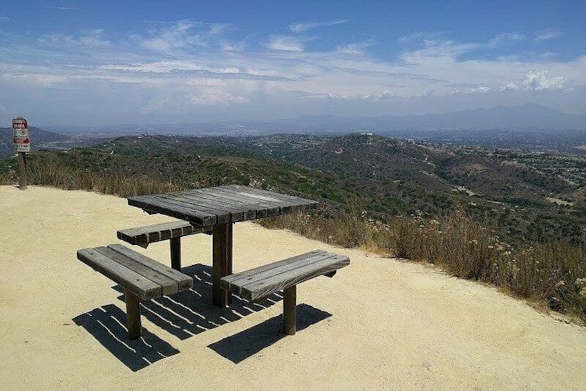 A picnic table on a hill with a view of the landscape. 5