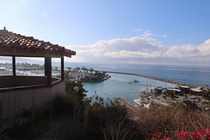 A coastal view with a gazebo, a marina, and a clear sky. 2