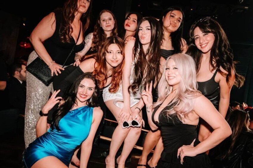 A group of people at a social event, some wearing formal attire. 5