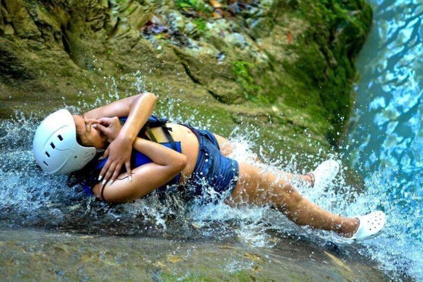 A person in a helmet and life jacket, partially submerged in water, likely engaging in water-based adventure sports. 5