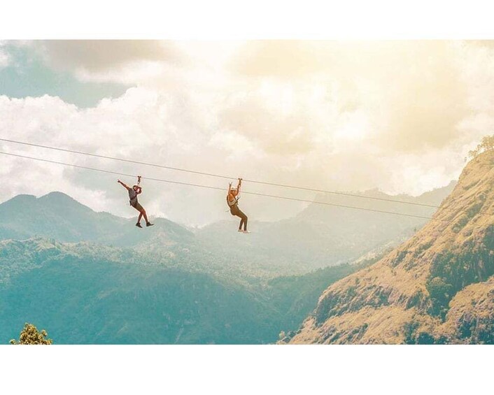 Two people walking on a suspended cable between mountains. 5