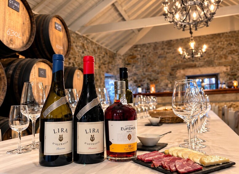 Three bottles of LIRA wine, a bottle of Eufemia Porto, and a charcuterie board with meats and cheese. 3