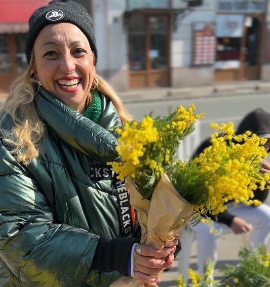A person holding a bouquet of yellow flowers. 2