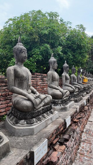 A row of seated stone Buddha statues. 4