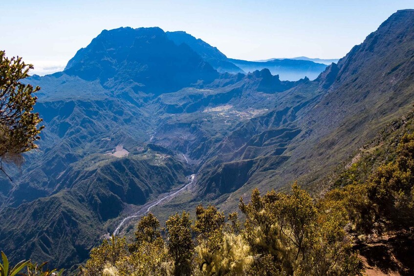 A mountainous landscape with a winding road and dense vegetation. 3