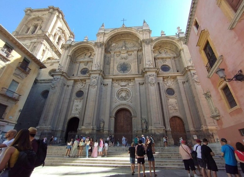 A historic church with ornate architecture and a crowd of people in front. 3