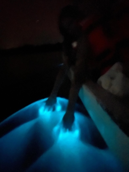 A person sitting on a couch with a blue glow. 3