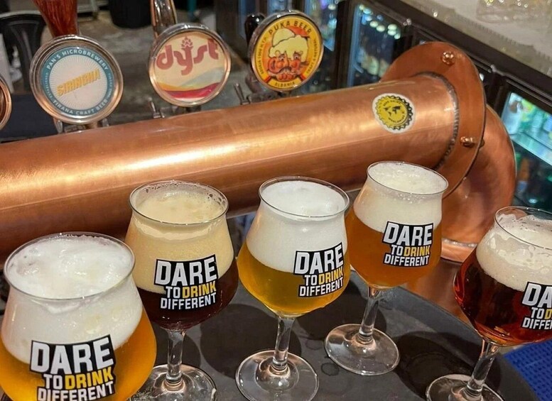A bar with taps and glasses labeled 'Dare to Drink Different.' 2