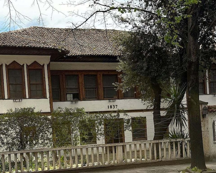 A traditional building with a tiled roof and the number 1837 on its facade. 3