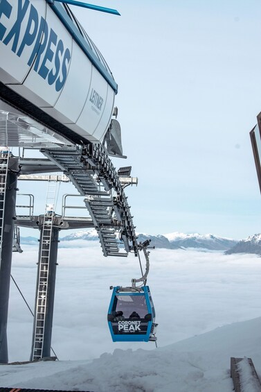 A chairlift with 'EXPRESS' and 'LETNER' branding, a snow-covered mountain landscape, and a 'CORONET PEAK' sign. 1