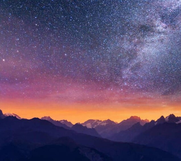 A starry night sky over a mountain range. 1