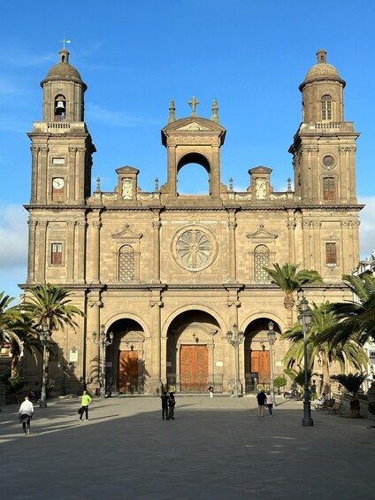 A historic cathedral with two bell towers, a central dome, and a large arched entrance. 2