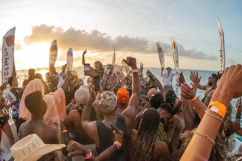 A beachside gathering with people holding surfboards and flags. 4