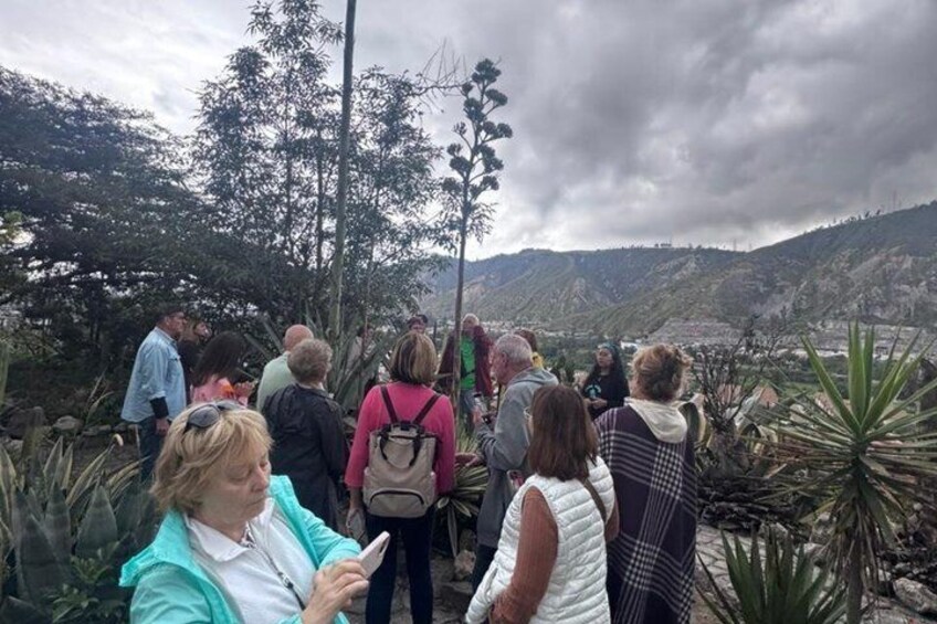 A group of people walking on a trail surrounded by vegetation and hills. 3