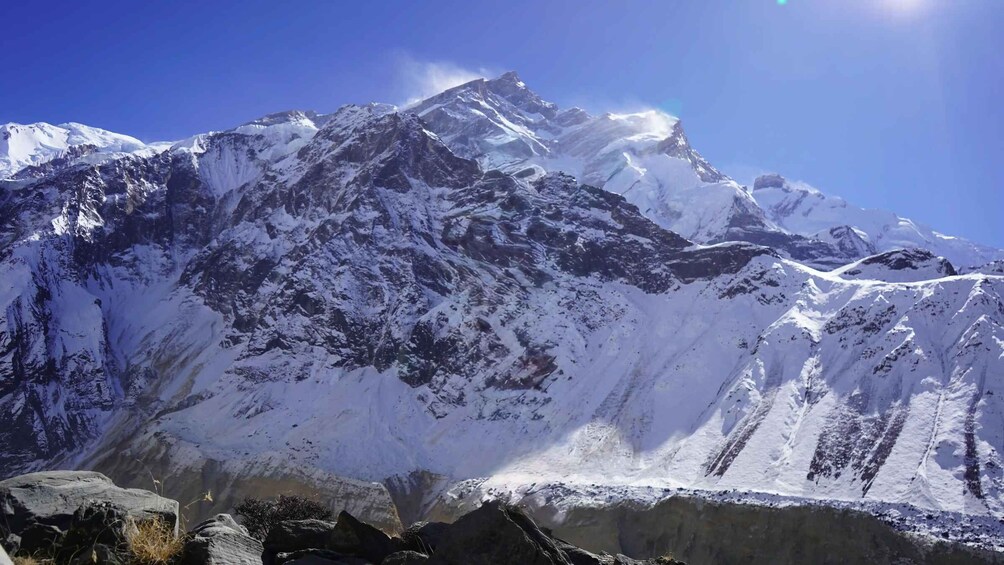 A snow-covered mountain range with rugged peaks and rocky outcrops. 3