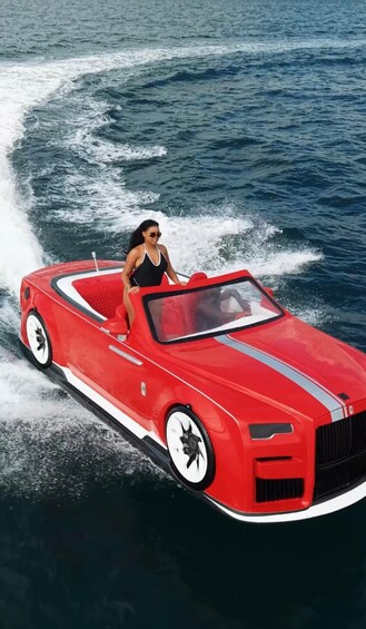 A red convertible car driving on water. 5