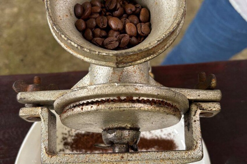 A coffee grinder with coffee beans inside. 3