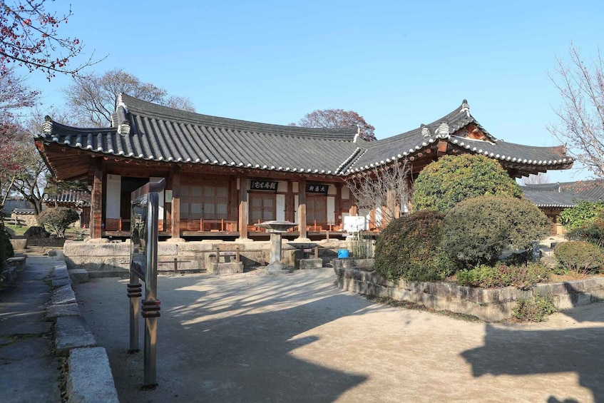 A traditional Korean building with a tiled roof and wooden structure. 1