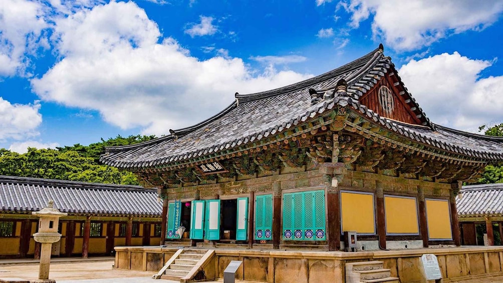 A traditional Korean building with ornate roof tiles and colorful doors. 5