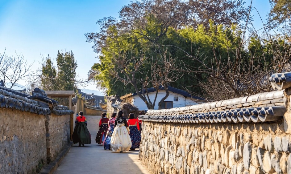 A traditional Korean village with stone walls and tiled roofs. 4