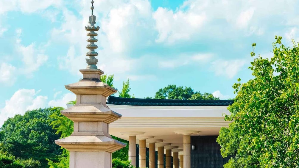 A traditional temple with a tiered stupa and a covered entrance. 3