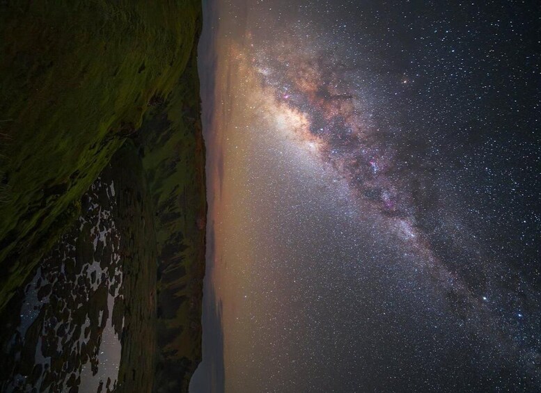 A night sky with the Milky Way over a mountainous landscape. 4