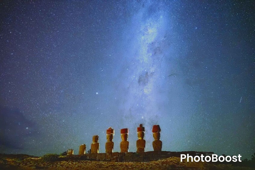 A night sky with stars and the Milky Way, and a row of Moai statues. 5
