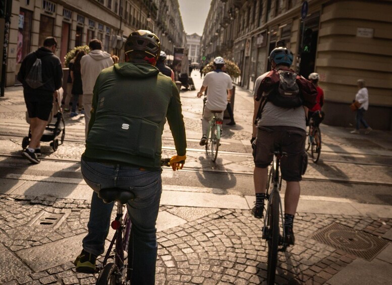 A cobblestone street with cyclists and pedestrians. 1