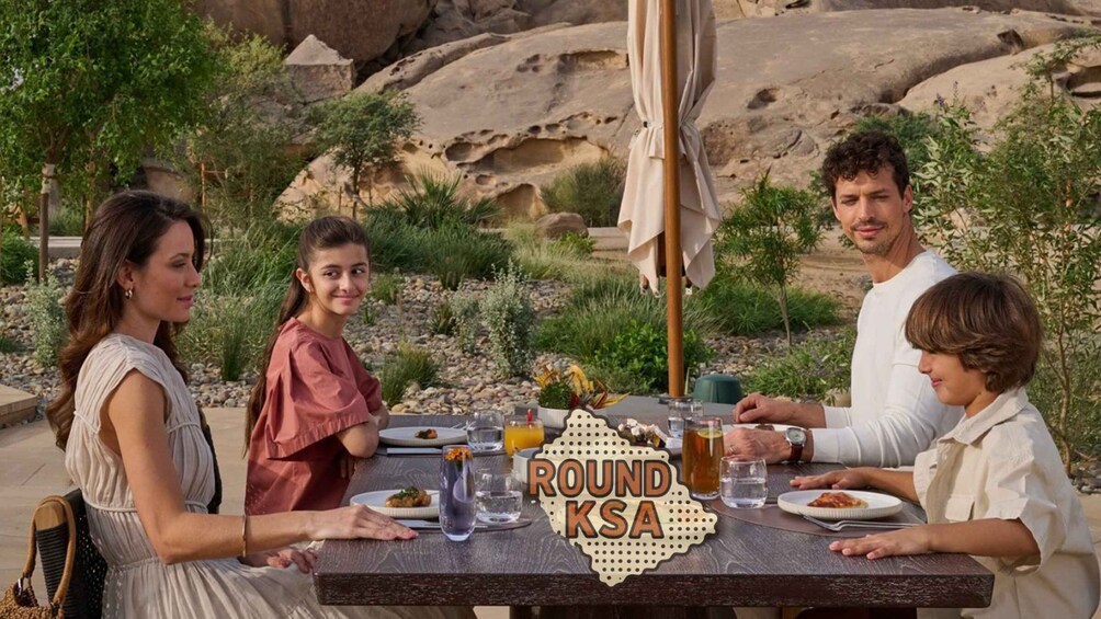 A family dining outdoors with a table labeled 'ROUND KSA.' 5