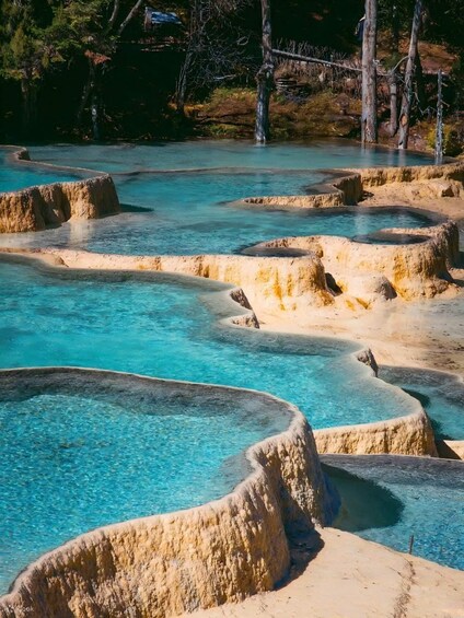 Terraced hot springs with clear turquoise water. 5