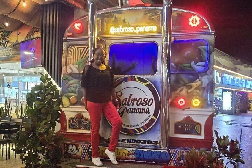 A person standing in front of a bus with 'Sabroso Panama' written on it. 4