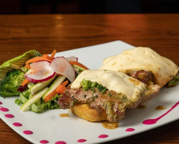 A sandwich with a side salad on a white plate with pink accents. 4