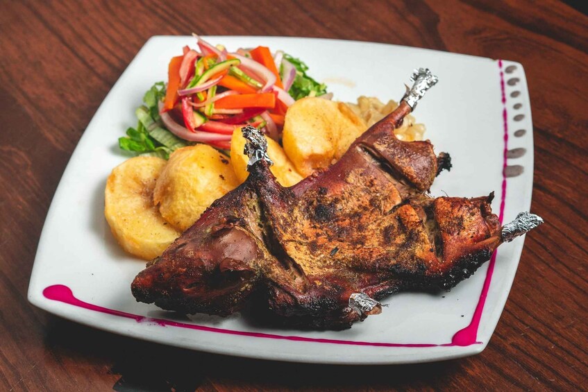 A roasted duck leg with skin crisped, served with roasted potatoes and a side salad. 3